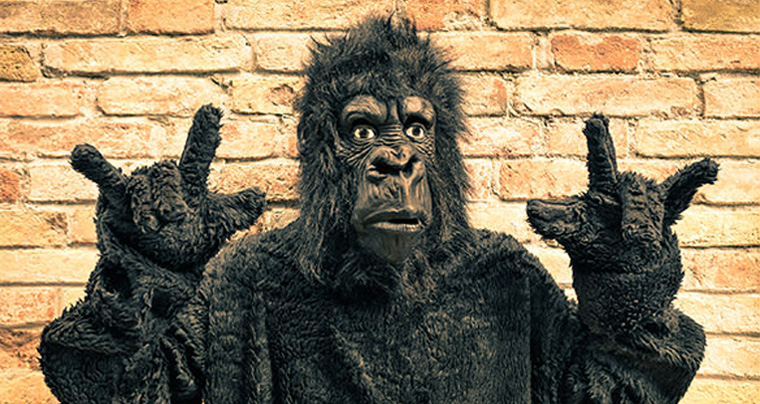 realistic gorilla suit is standing in front of the old yellow bricks
