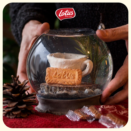 lotus biscoff social media visual, snow globe and hands